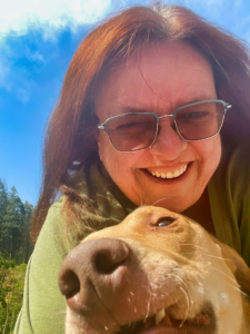 Picture of smiling woman hugging her dog.