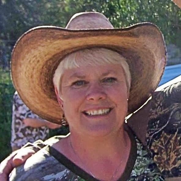 Picture of woman wearing a straw cowboy hat.